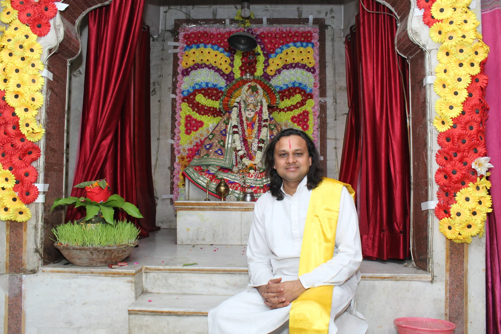 Acharya Vikramaditya seated before a shrine